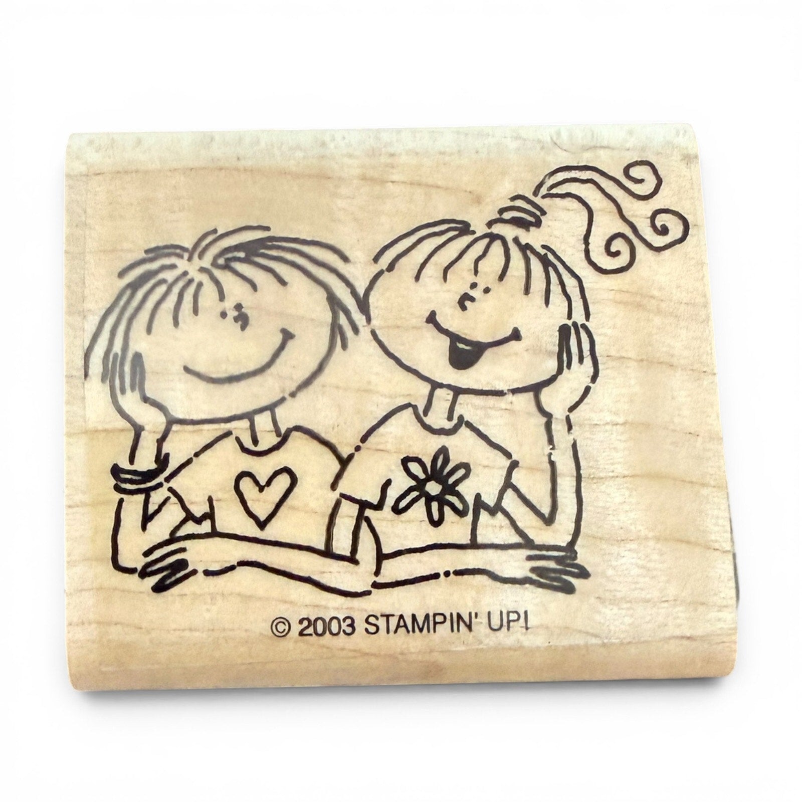 Wooden stamp with illustrations of two children on a white background, featuring the 'Stampin' Up!' brand.