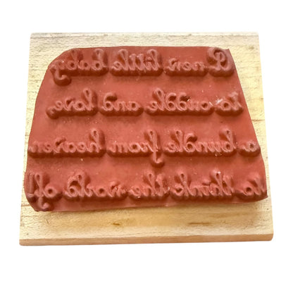 Wooden stamp with embossed text on a white background