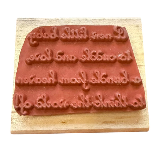 Wooden stamp with embossed text on a white background