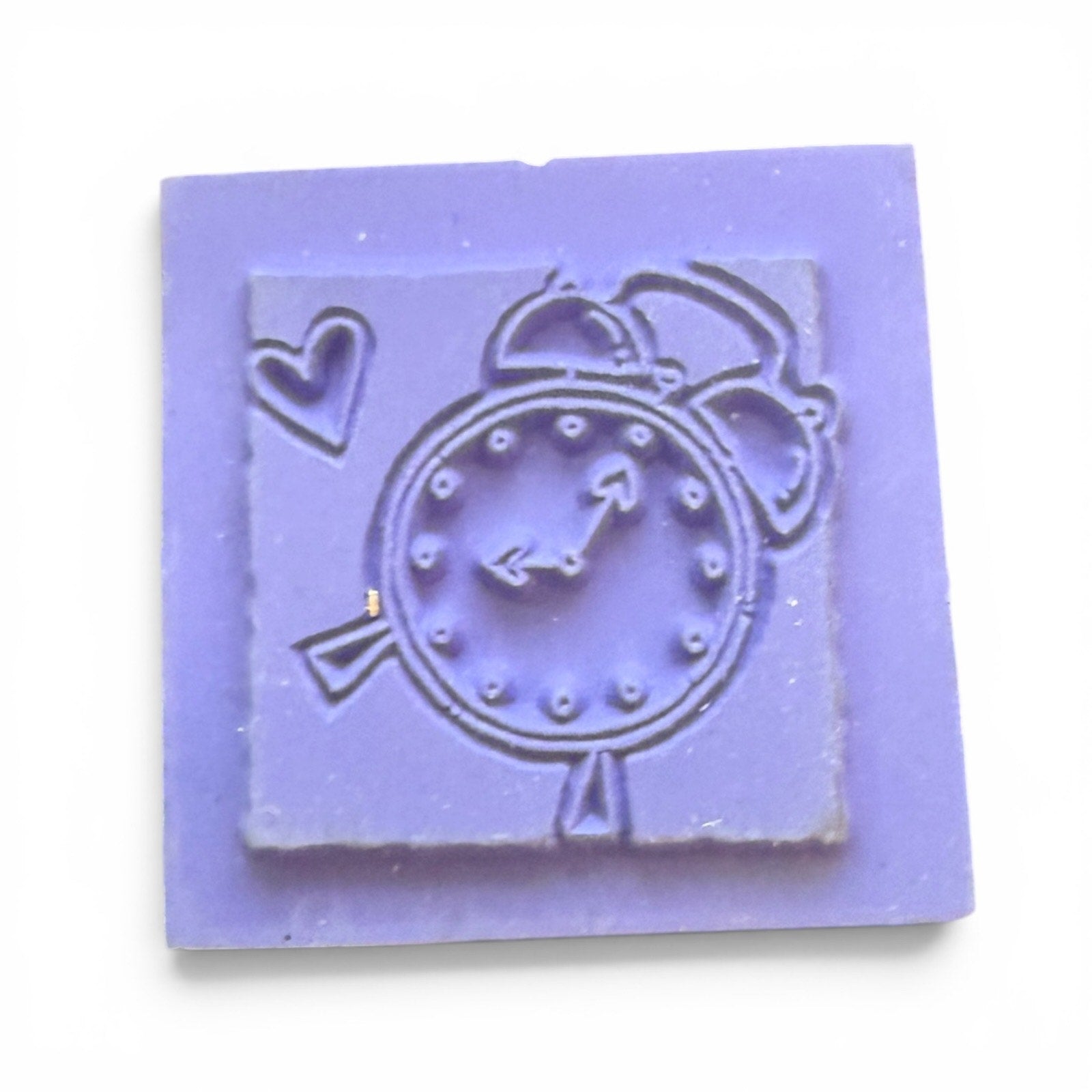 Purple square stamp with a clock design on a white background