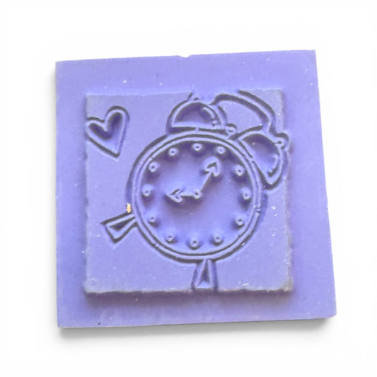 Purple square stamp with a clock design on a white background