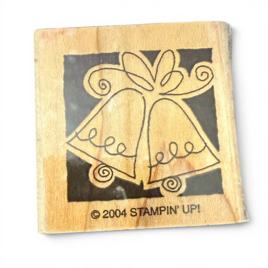 Wooden stamp with a design of two bells and a bow, featuring the 'Stampin' Up!' logo.
