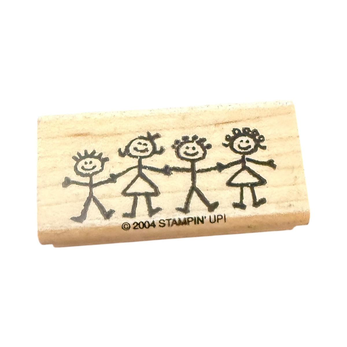Wooden stamp with stick figure family design and '2004 Stampin' Up!' branding on a white background.