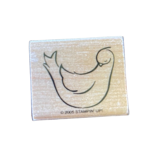 Wooden stamp block with a bird design on a white background