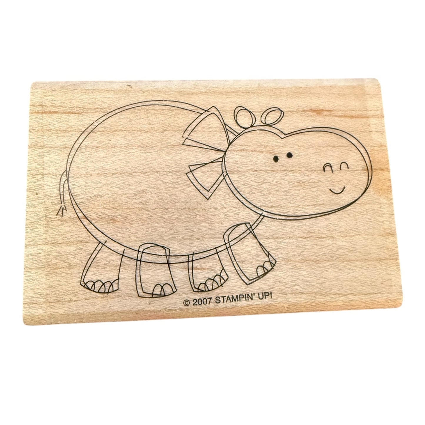 Wooden stamp with a hippo design on a white background