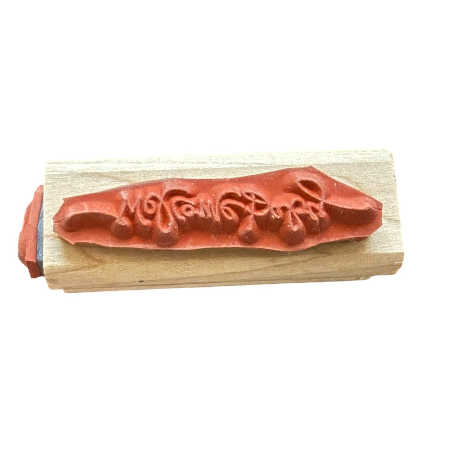 Wooden stamp with red ink pad on a white background
