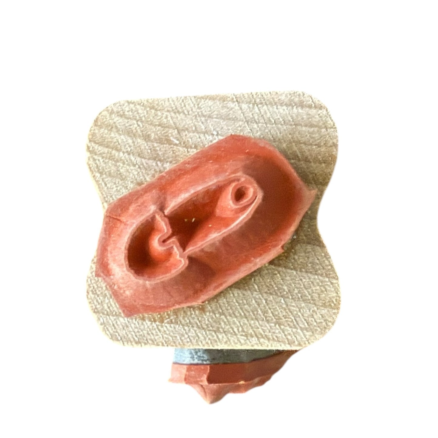 rubber stamp pn a wood block on a white background