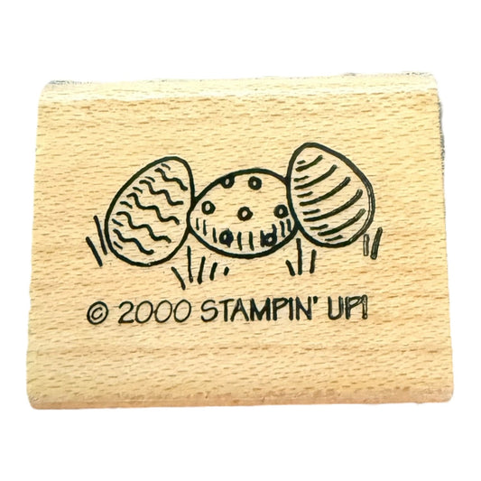 Wooden stamp with three stylized eggs and 'Stampin' Up!' branding on a white background