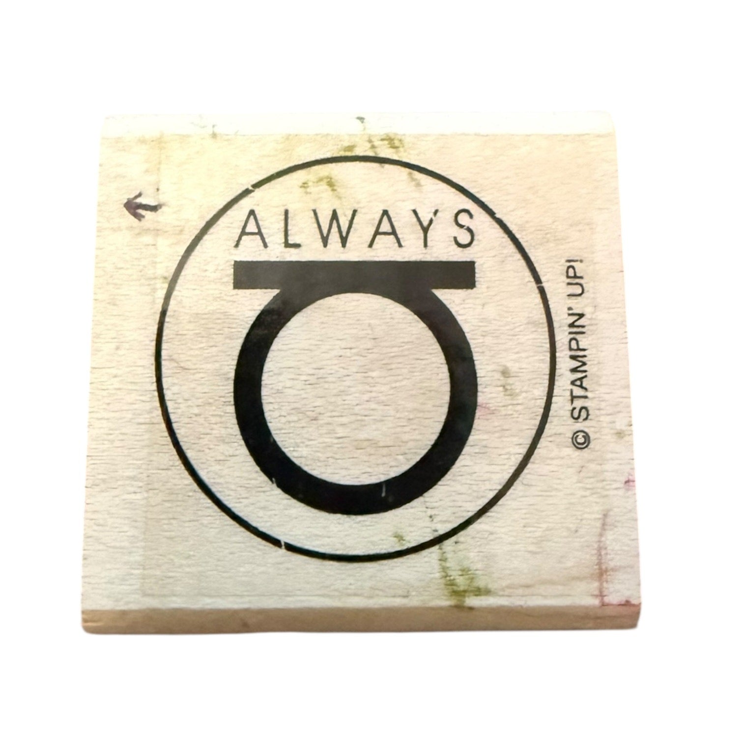 A square wooden rubber stamp block featuring a black printed design with the word 'ALWAYS' above a large stylized letter O, shown on a plain white background. Stampin' Upi branding is visible on the right side of the design.