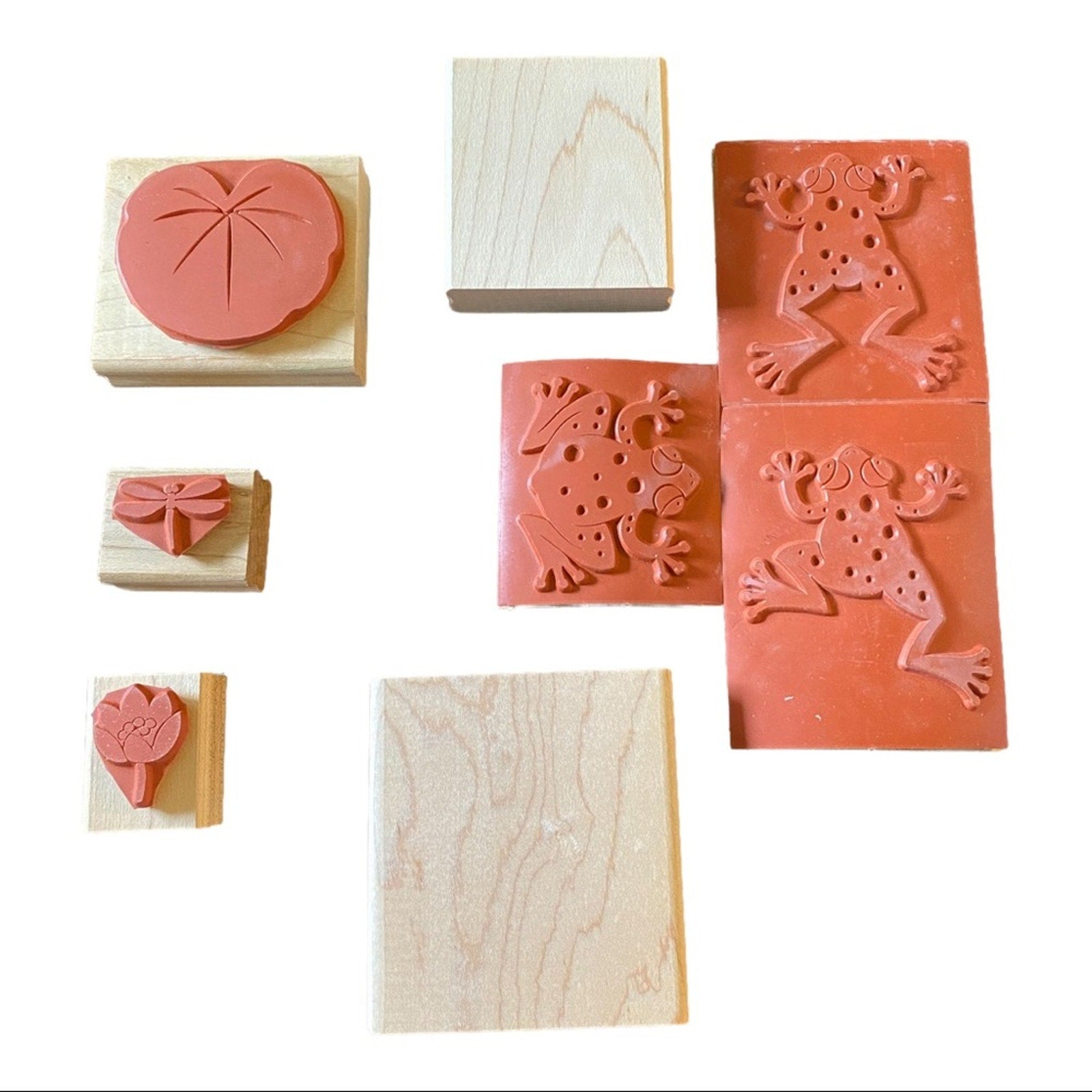 A set of wooden rubber stamps shown on a plain white background,rubber and two blank natural wood blocks.
