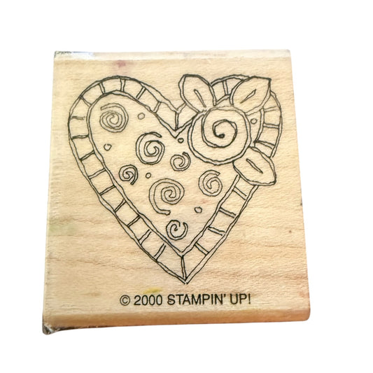 Wooden stamp with a heart design and 'Stampin' Up!' branding on a white background