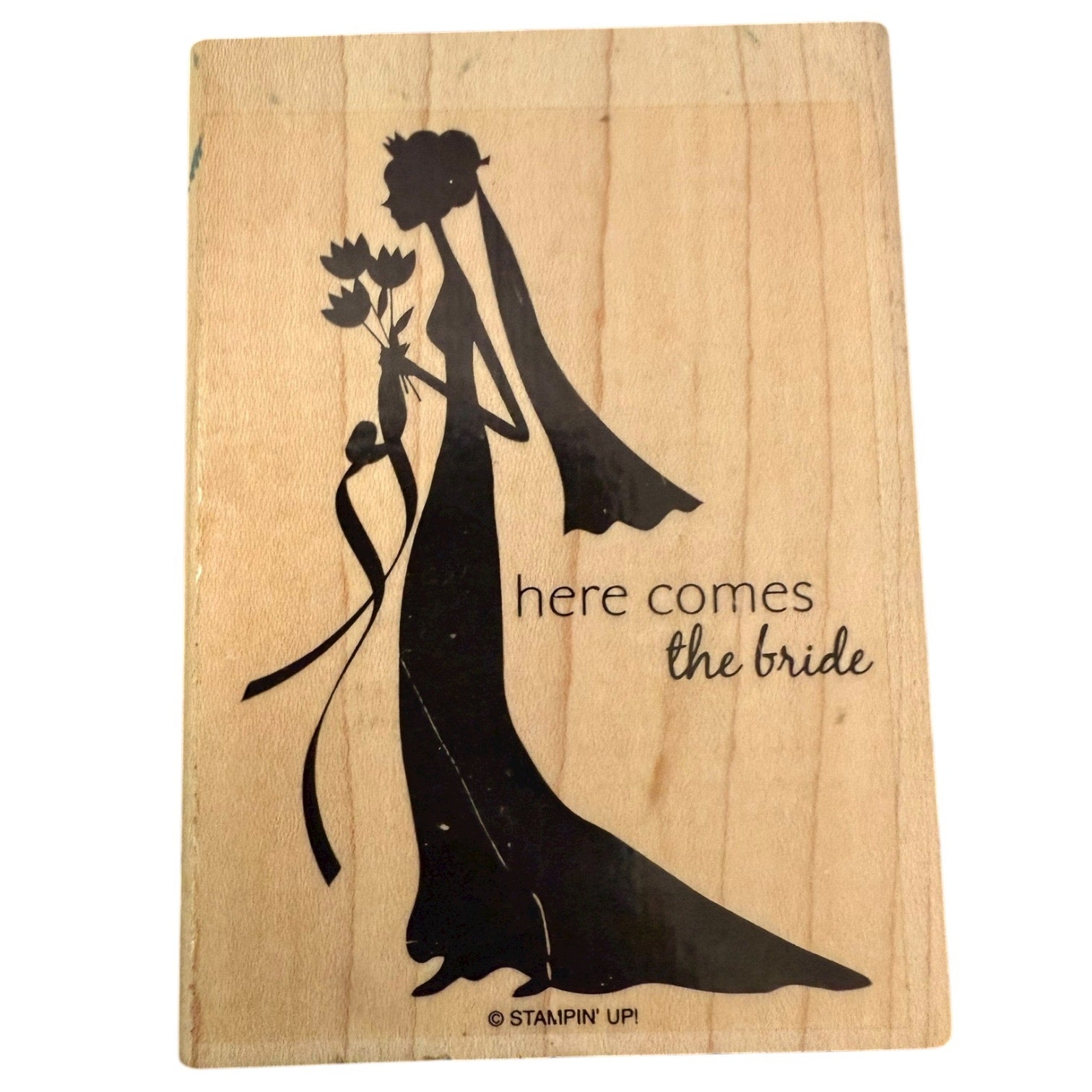 Wooden stamp with a black silhouette of a bride and 'here comes the bride' text, brand 'Stampin' Up!' visible.