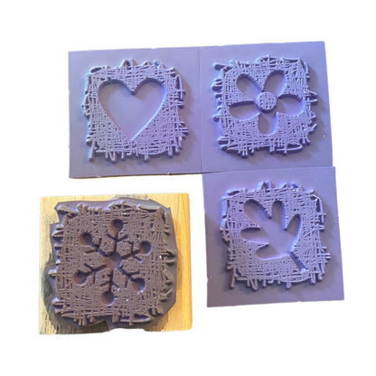 Four square rubber stamps shown on a white background.