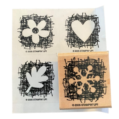 A set of four rubber stamps from Stampin' Up! featuring black ink designs of a flower, a heart, a leaf and a snowflake on a white sheet, with one wooden stamp shown in the bottom right corner.