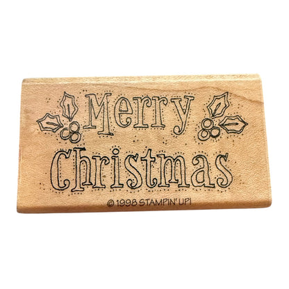 Wooden stamp with 'Merry Christmas' text on a white background