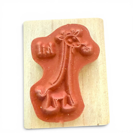 Wooden stamp with a giraffe on a white background