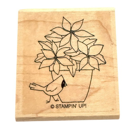 Wooden stamp with a design of a bird and potted plant, featuring 'Stampin' Up!' branding.