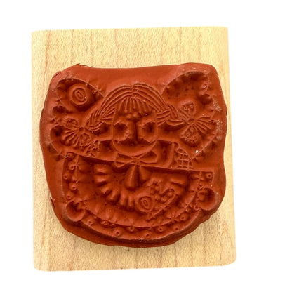 Decorative stamp with intricate design on a wooden block