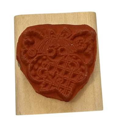 Decorative stamp with an angel design on a wooden block