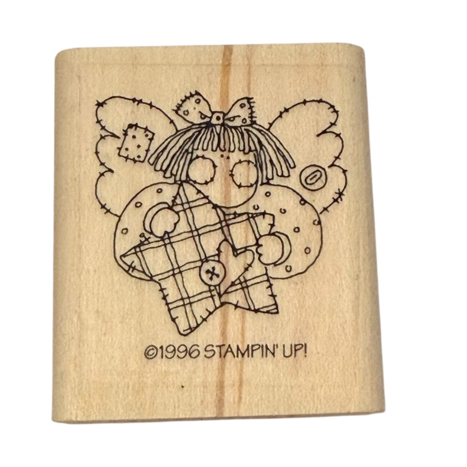 Wooden stamp with a design of an angel holding a star and the text '©1996 Stampin' Up!' on a white background.