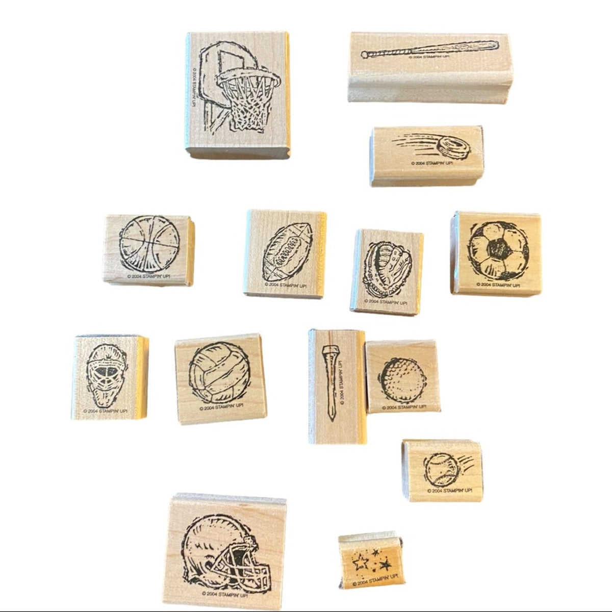 Lot of sports themed wood block rubber stamps on a white back ground. 