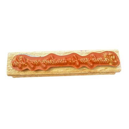 Wooden stamp with red rubber on a white background