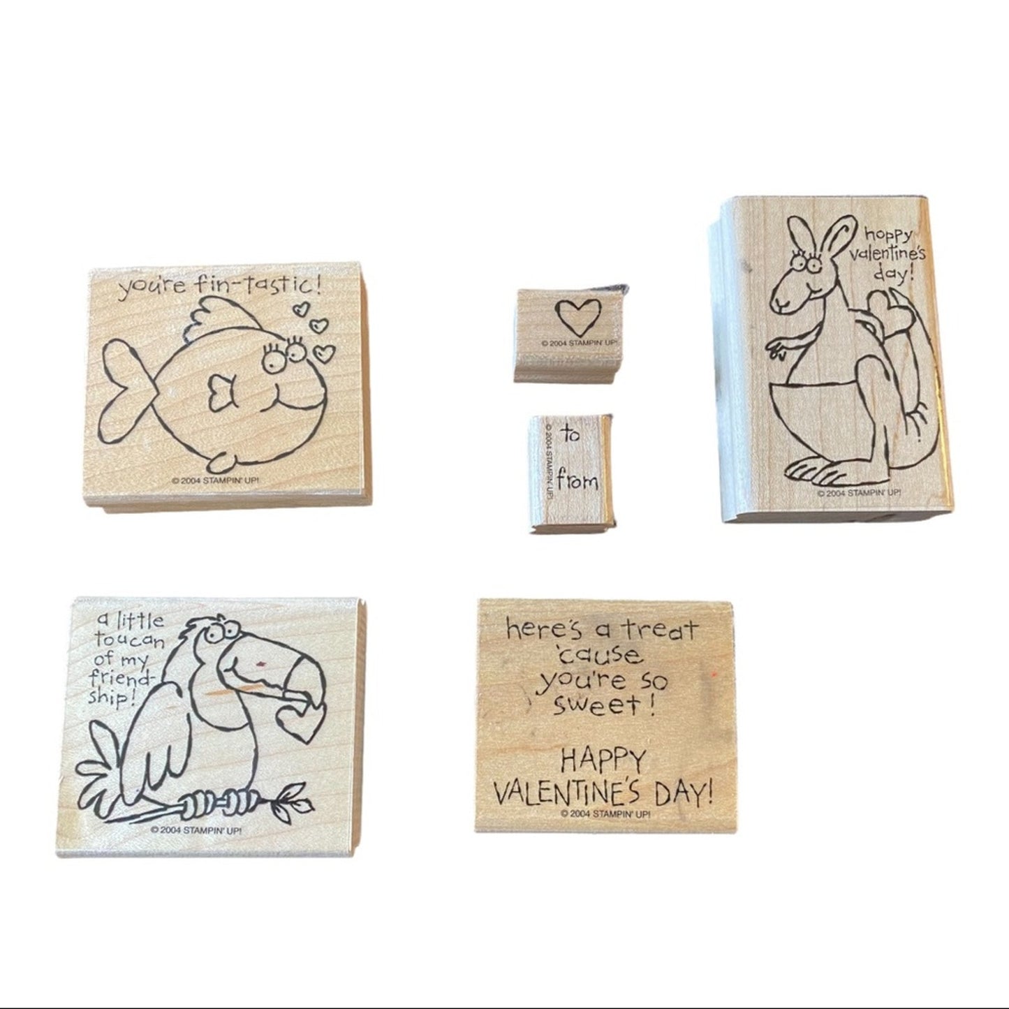 Set of wooden stamps with animal illustrations and text on a white background
