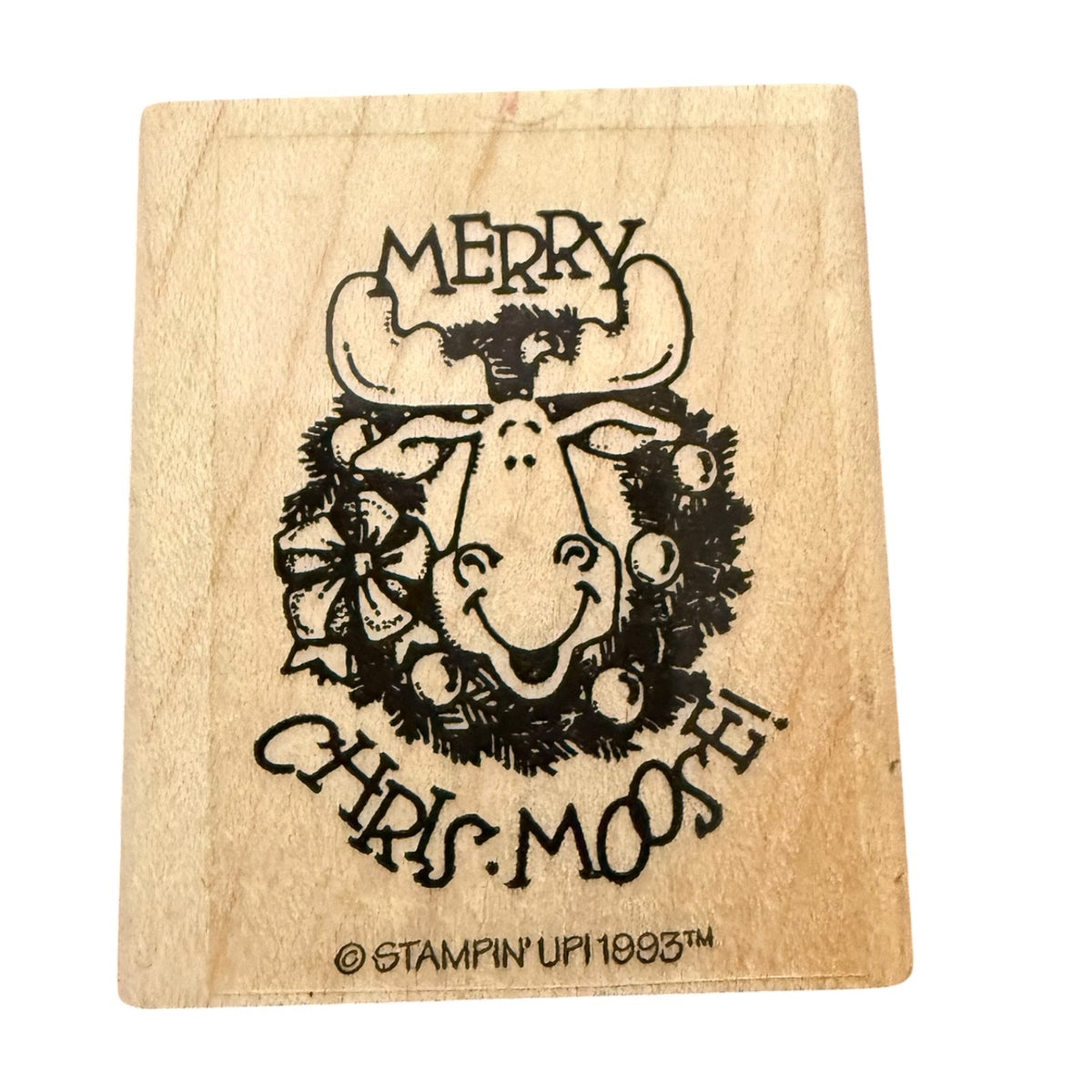 A square wooden rubber stamp featuring a design of a smiling Christmas moose wearing a wreath, with the text 'MERRY CHRIS MOOSE' and a copyright mark for Stampin' Up! 1993.