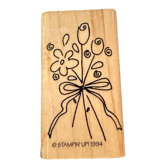 Wooden stamp with floral design and 'Stampin' Up! 1994' branding on a white background