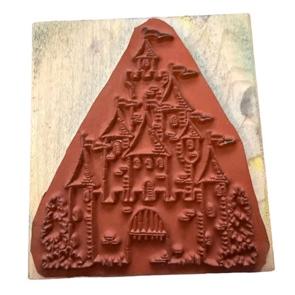 Castle rubber stamp on a wood block on a white background.