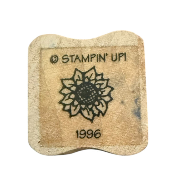 Wooden stamp with 'Stampin' Up!' branding and a sunflower design on a white background