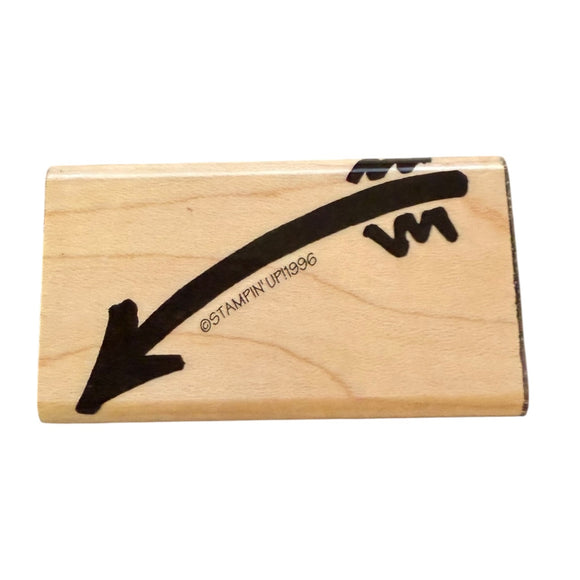 Wooden stamp with black arrow design on a white background