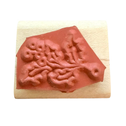 Rubber stamp on a wood block with a white background. 