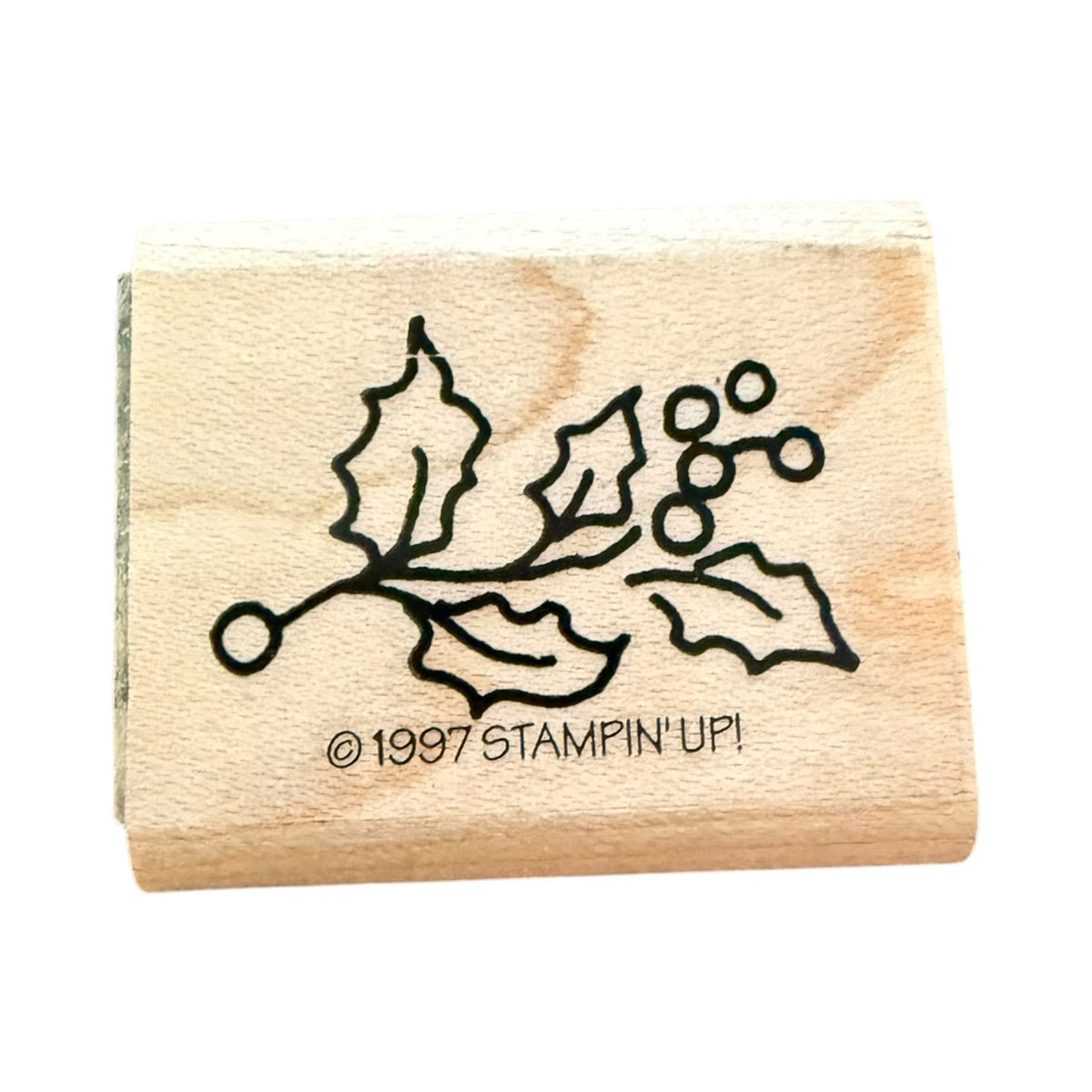 Stampin Up Holly leaf with berries on a wood block with a white background. 