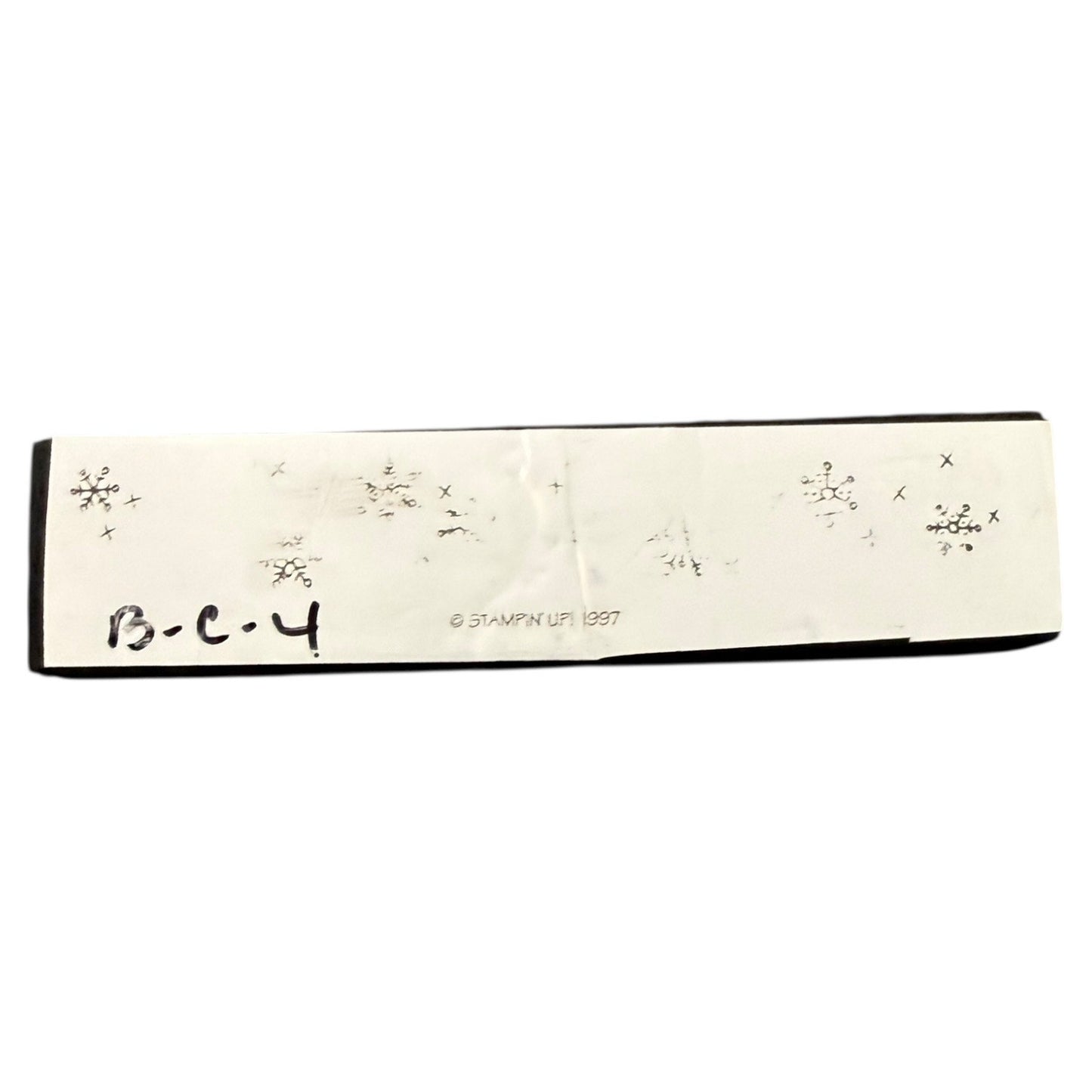 Rectangular stamp with snowflake designs and text on a white background
