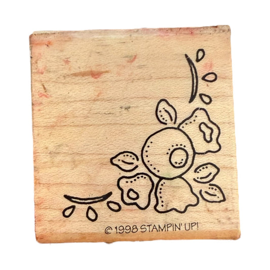 A square wooden rubber stamp block featuring a floral design and the text '© 1998 STAMPIN' UP!', shown on a plain white background.