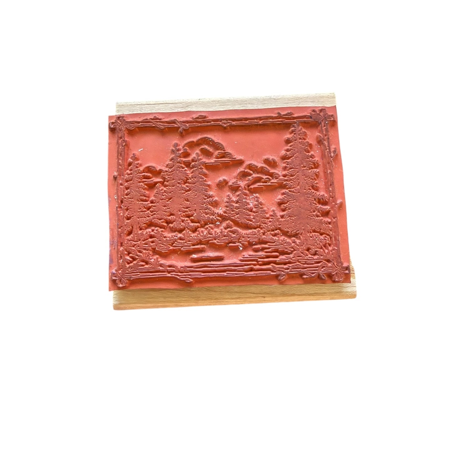 Decorative wooden block with embossed design on a white background