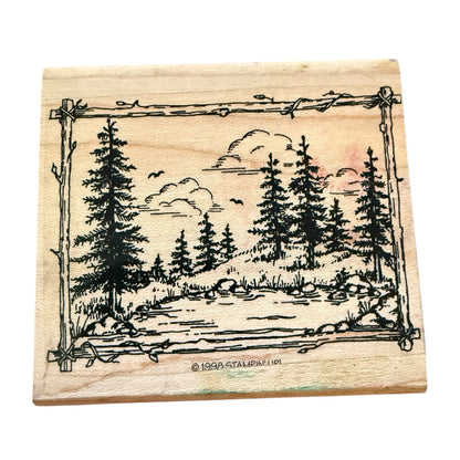 Wooden stamp with a nature scene design featuring trees and a landscape.