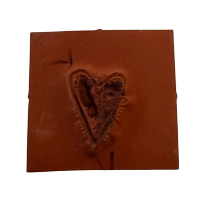 A square heart rubber stamp shown against a plain white background.