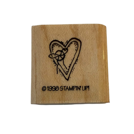 A square wooden rubber stamp block with a heart design and the text '© 1998 STAMPIN' UP!'.