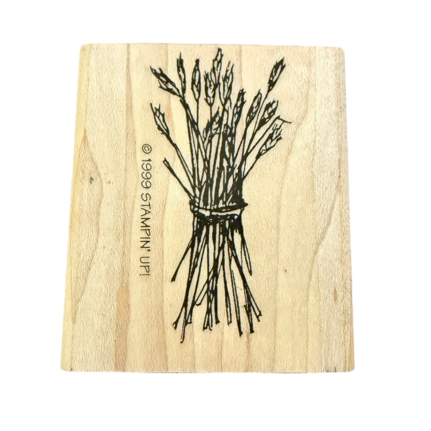 A rectangular wooden stamp block with a black line drawing of a tied bundle of wheat , shown on a plain white background.
