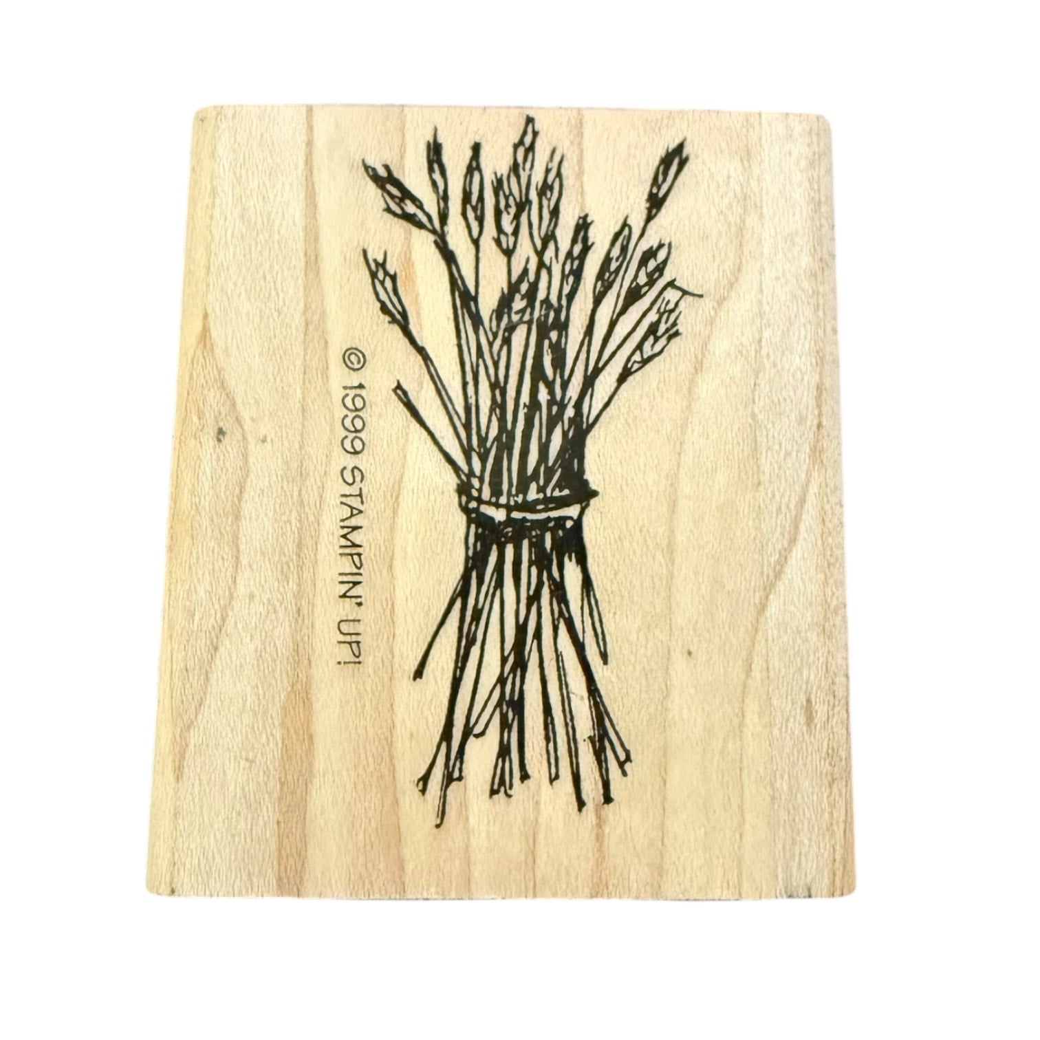 A rectangular wooden stamp block with a black line drawing of a tied bundle of wheat , shown on a plain white background.