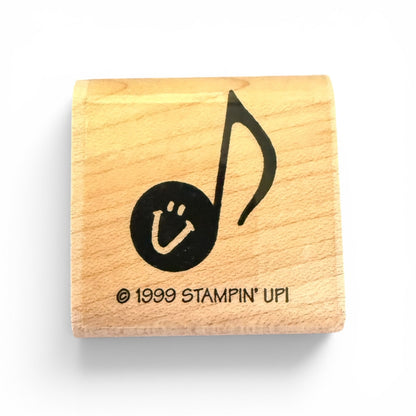 Wooden stamp with a musical note and smiley face design, featuring '1999 Stampin' Up!' branding.