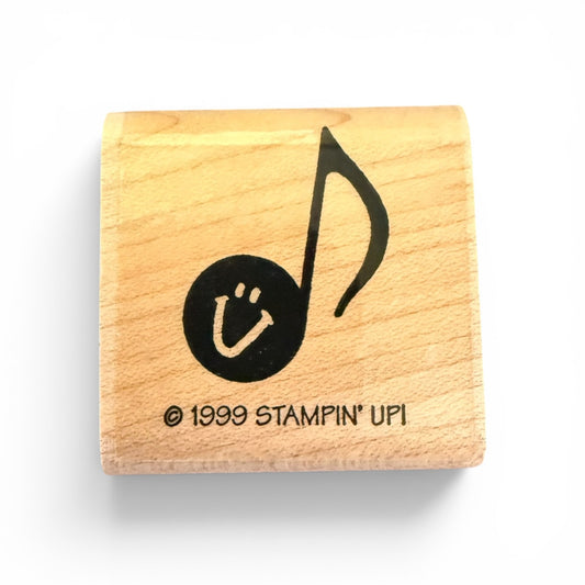 Wooden stamp with a musical note and smiley face design, featuring '1999 Stampin' Up!' branding.