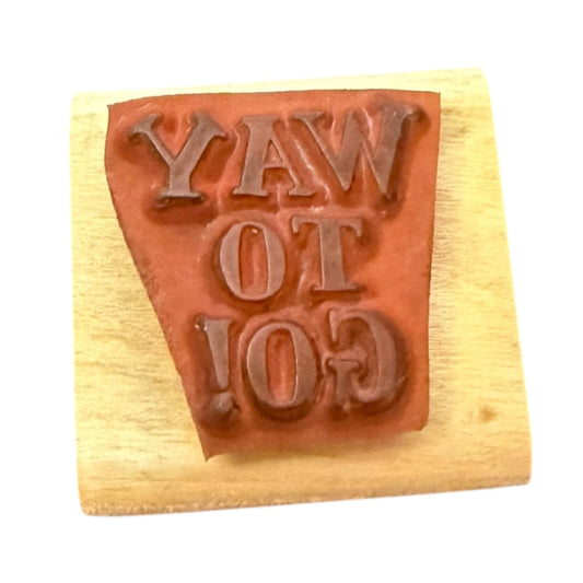 Wooden stamp with 'WAY TO GO!' text on a white background