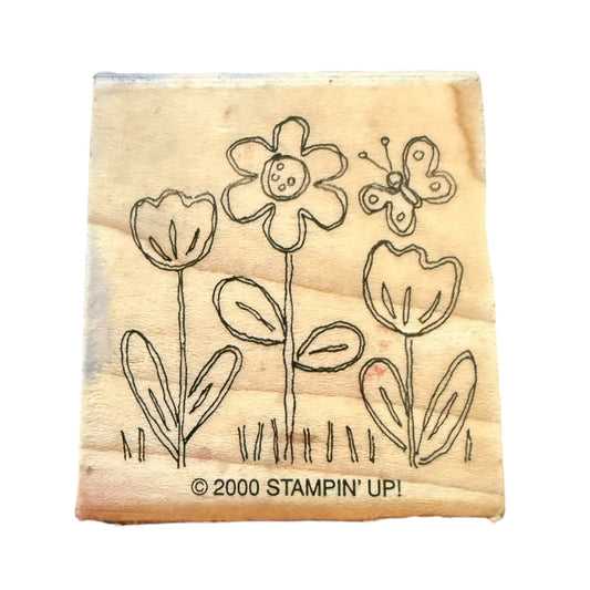 Wooden stamp block with floral design and 'Stampin' Up!' branding on a white background