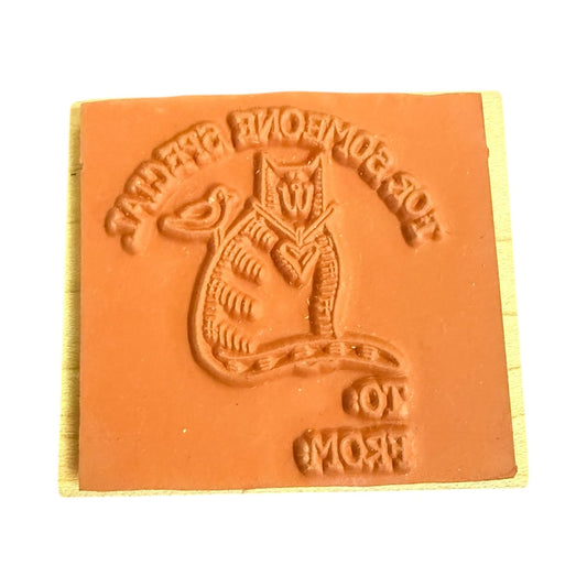 stamp with a cat design and text on a white background