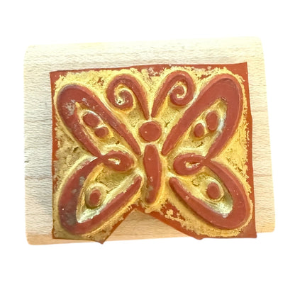 Rubber stamp with butterfly design on a white background