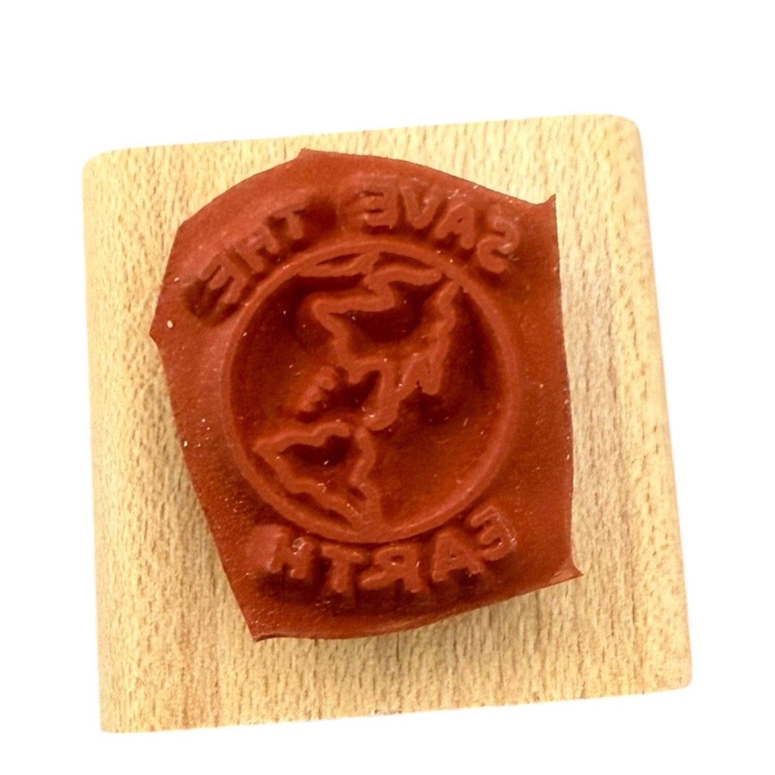 Wooden block with a red rubber stamp on a white background