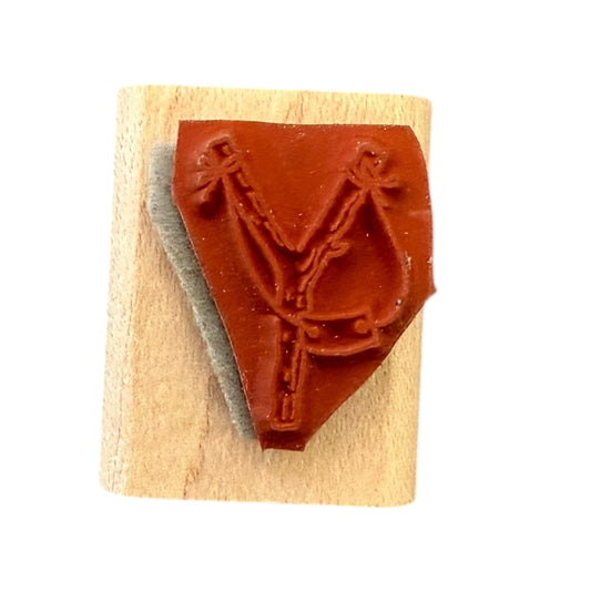 Wooden stamp with a sling shot design on a white background